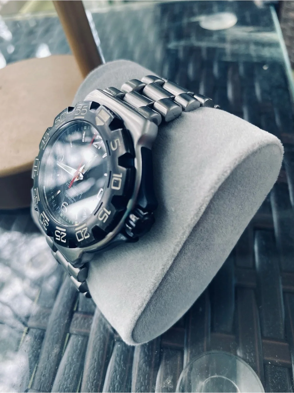 Tag Heuer stainless steel watch with black dial and red seconds hand